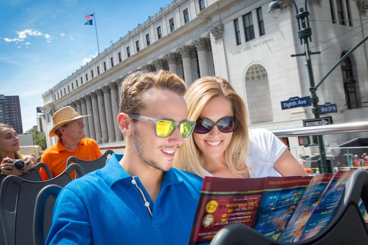 a man and woman reading a map on a bus