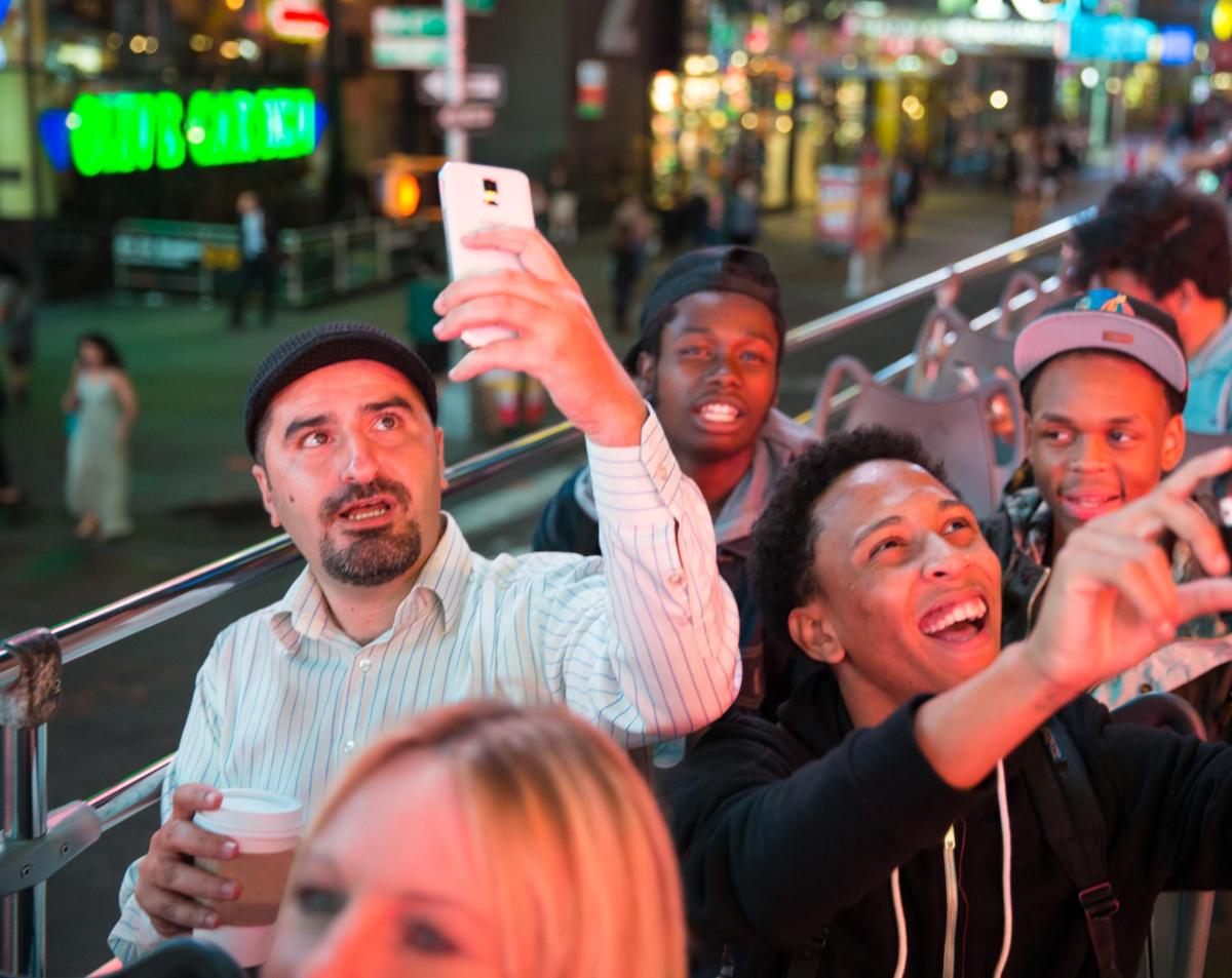 a group of people holding up their cell phones