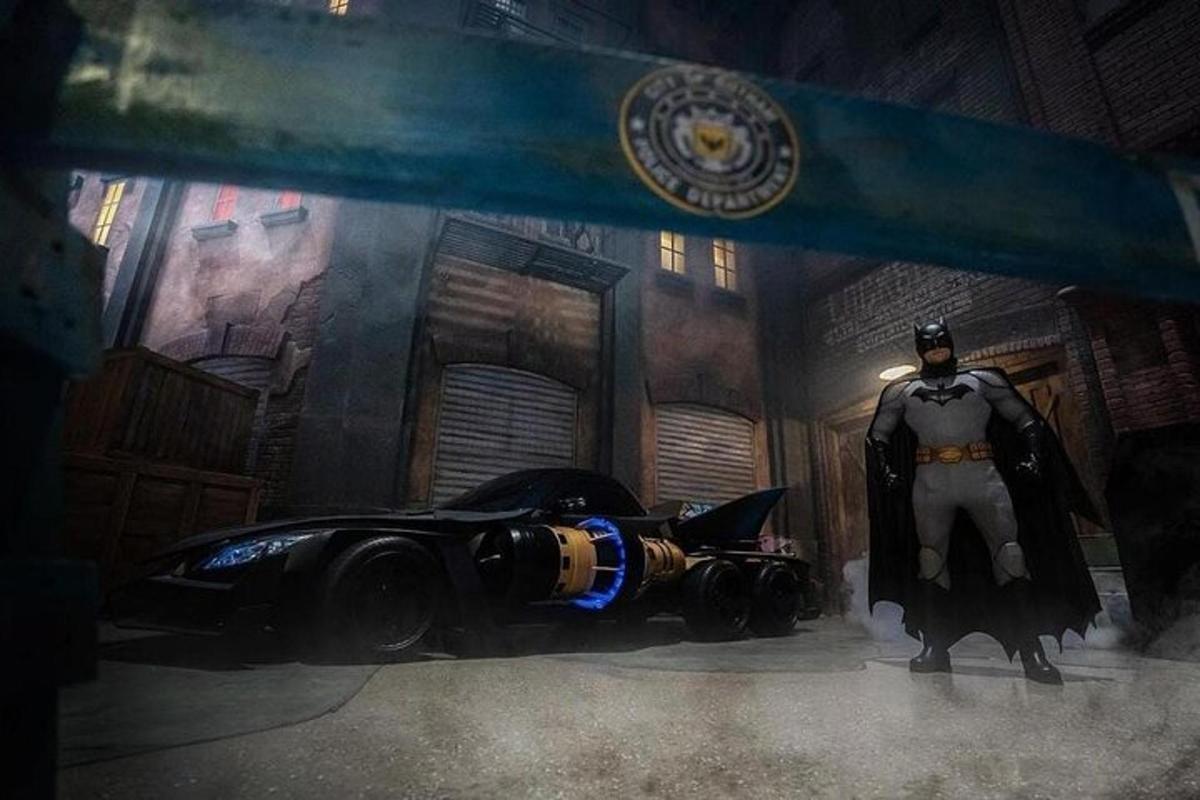a batman standing next to a car in a room