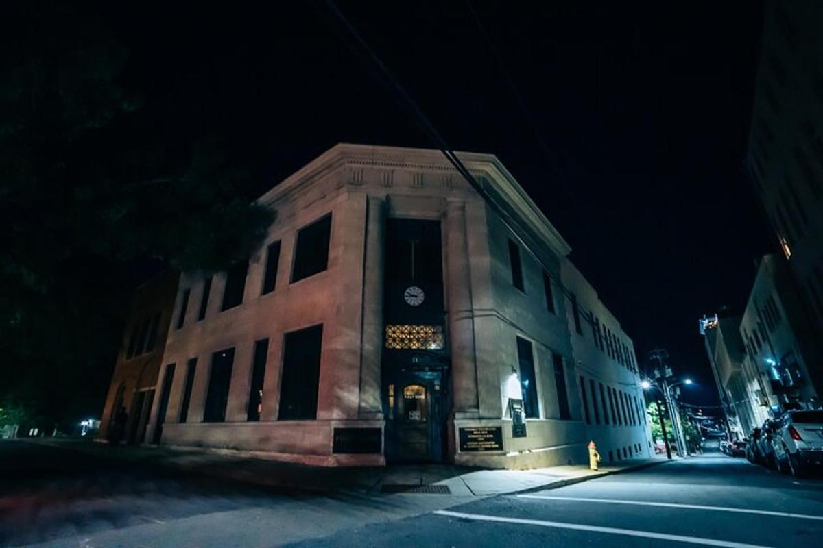 a building with a clock on the front of it at night