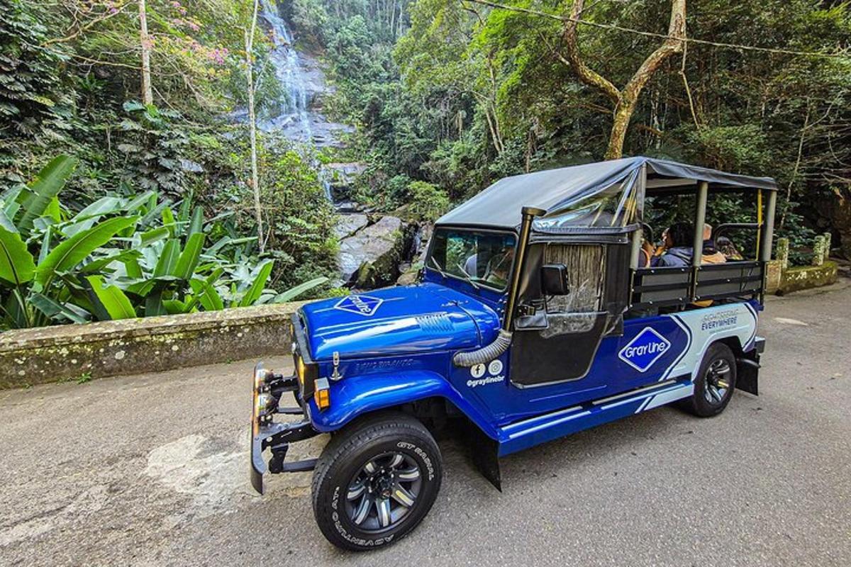 a blue golf cart driving down a road