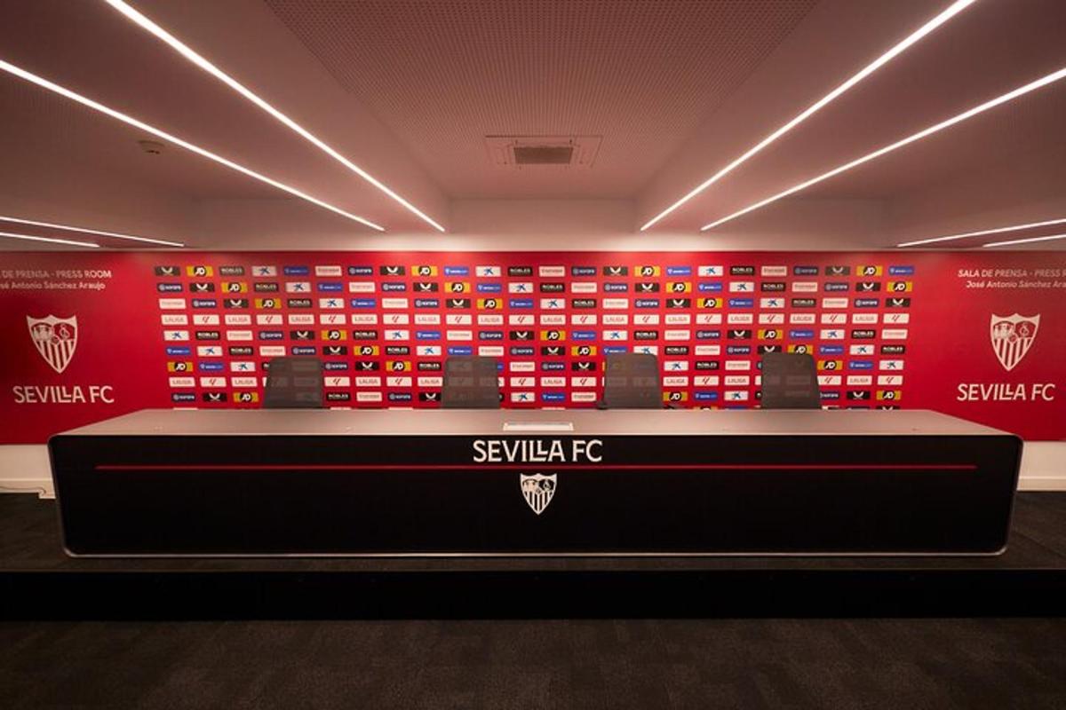 a room with a display of differentttenham jerseys