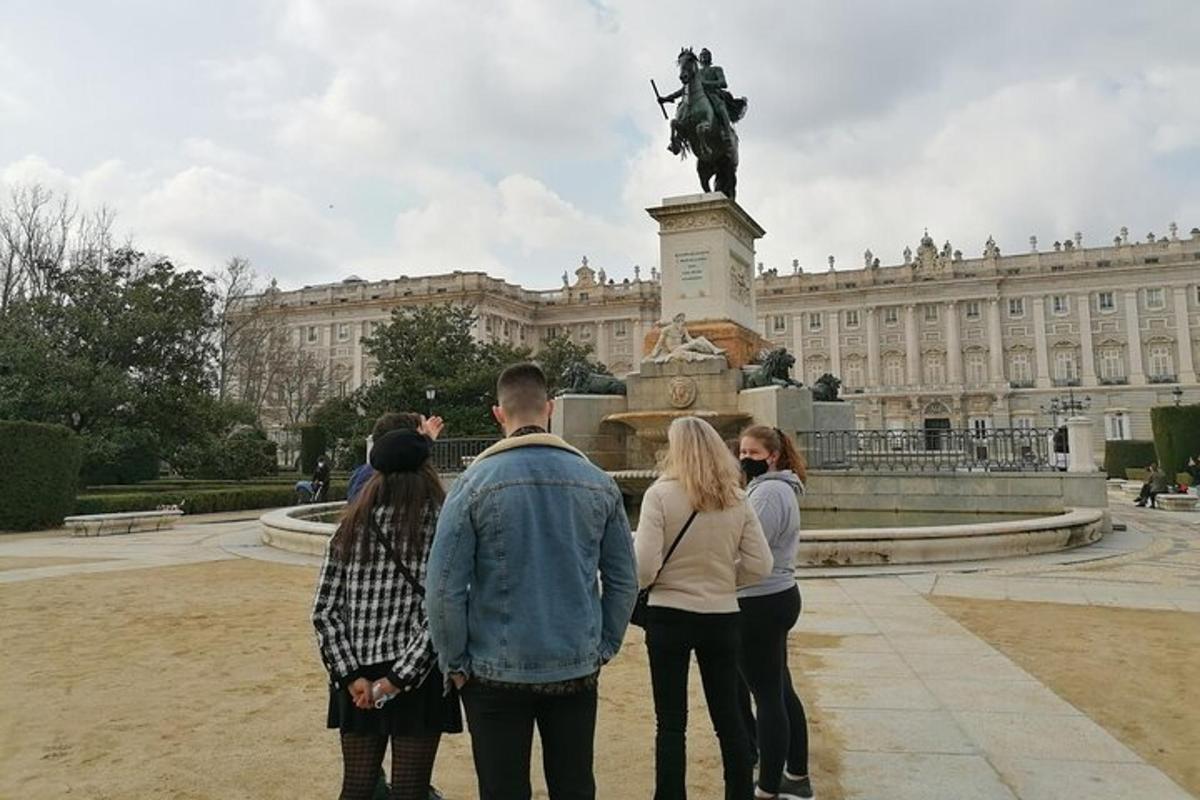 a group of people standing around a statue in front of a building
