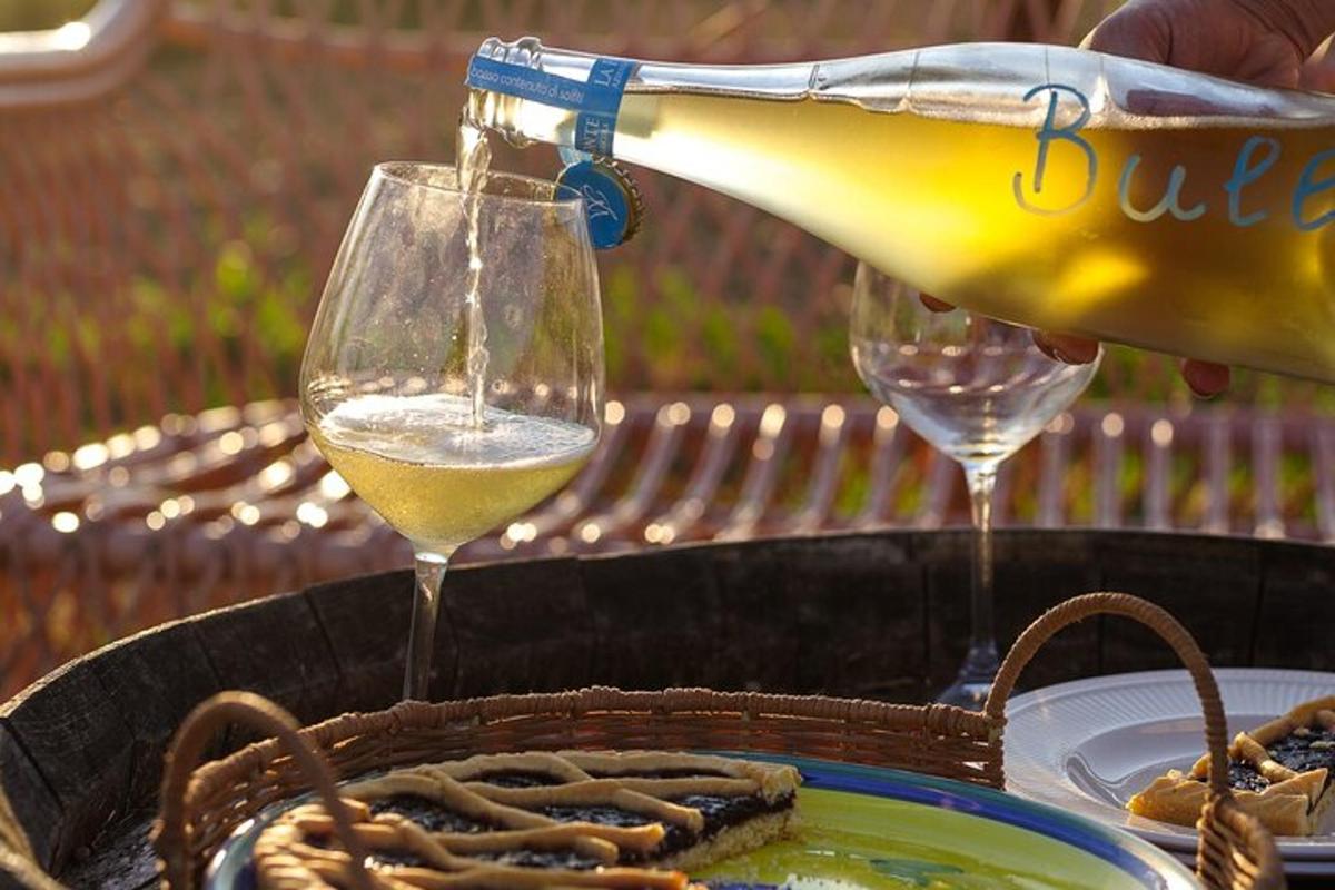 a person pouring a glass of wine on a table