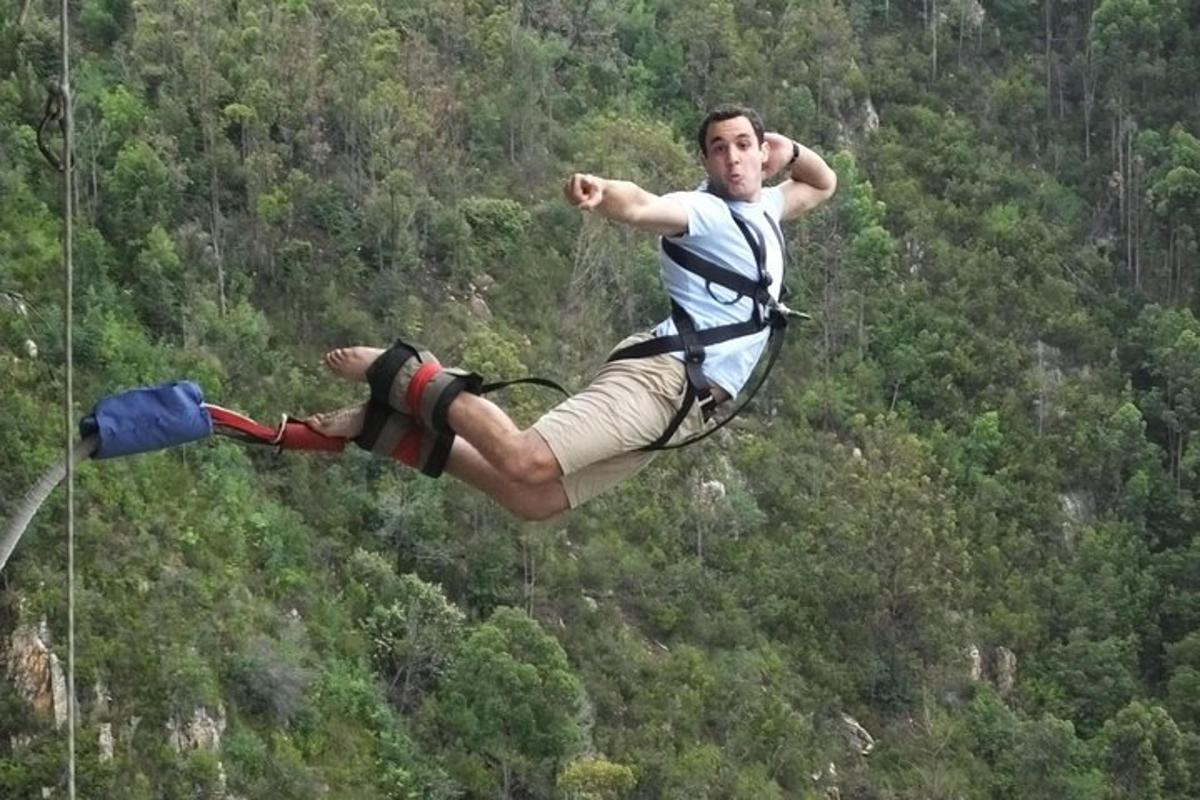a man flying through the air while on a parachute