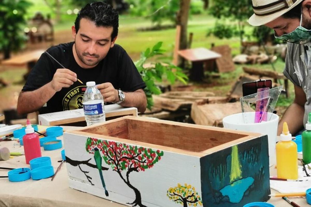 a man sitting at a table with a tree painted on it