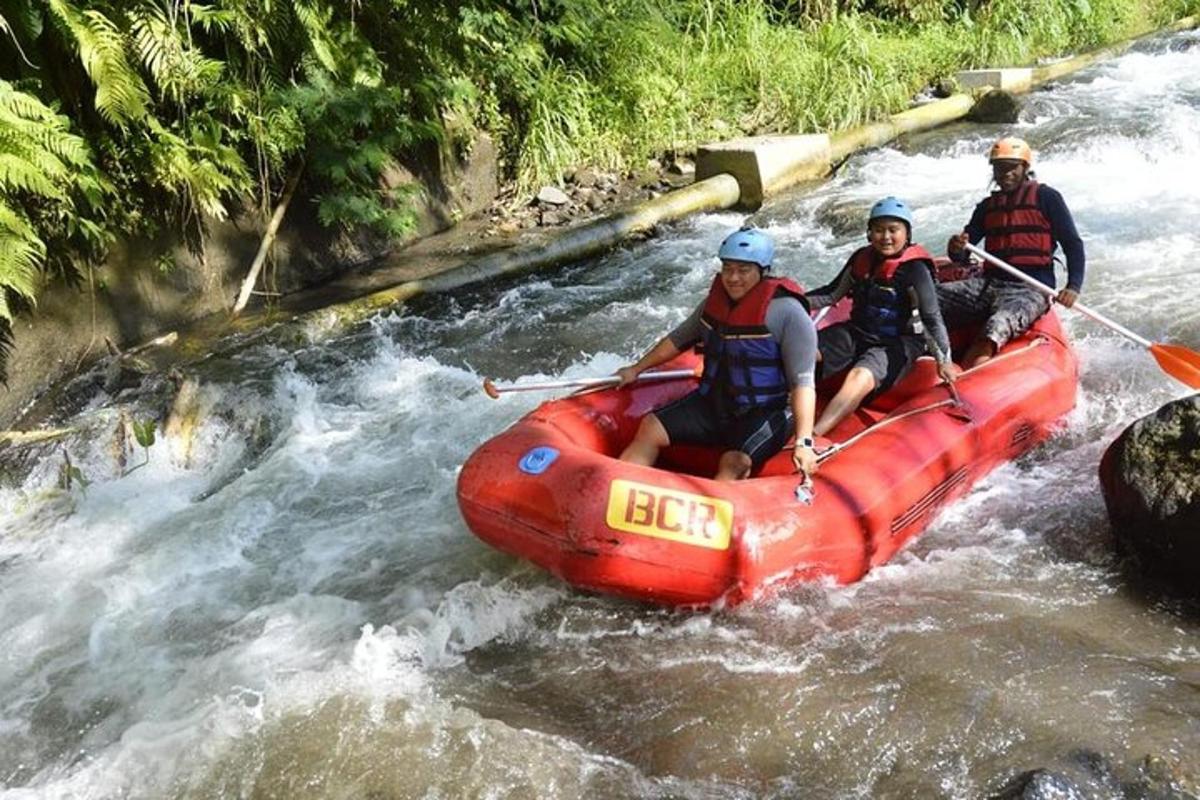 three people in a red raft in a river