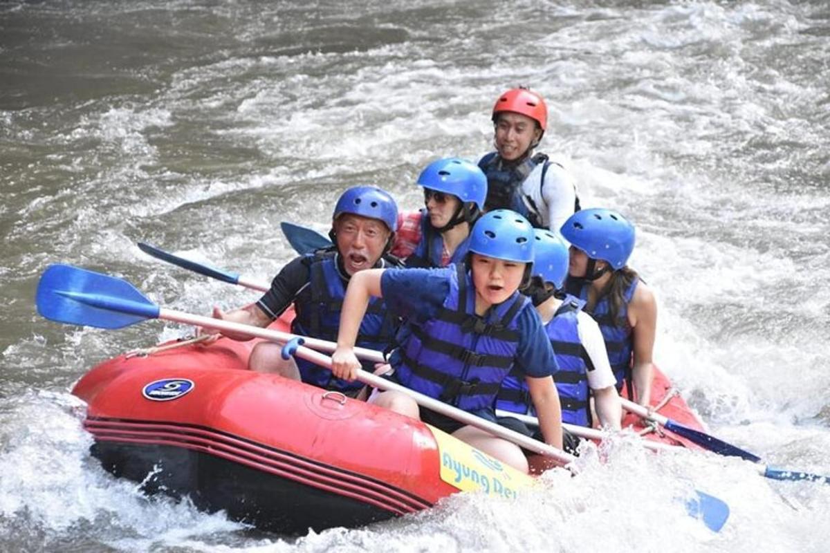 a group of people in a raft in the water