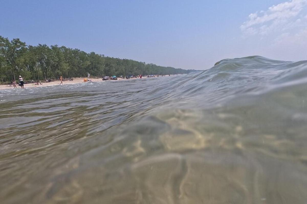 a body of water with a group of people on a beach