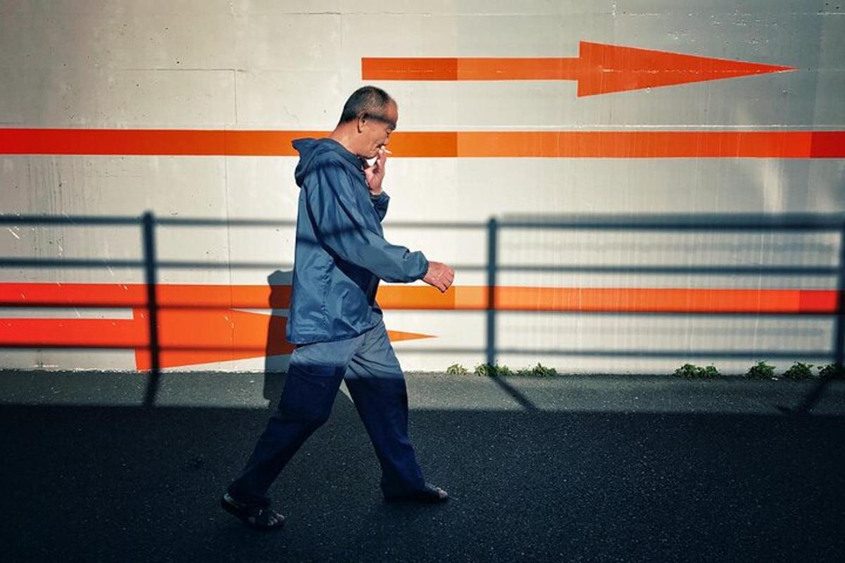 a man walking down the street while talking on a cell phone