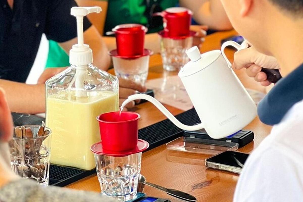 a group of people sitting at a table with a bottle of orange juice