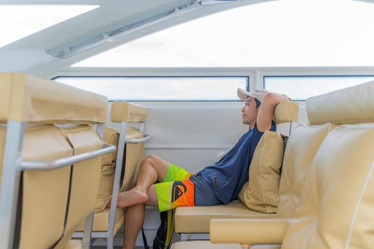 a man sitting on a train reading a book