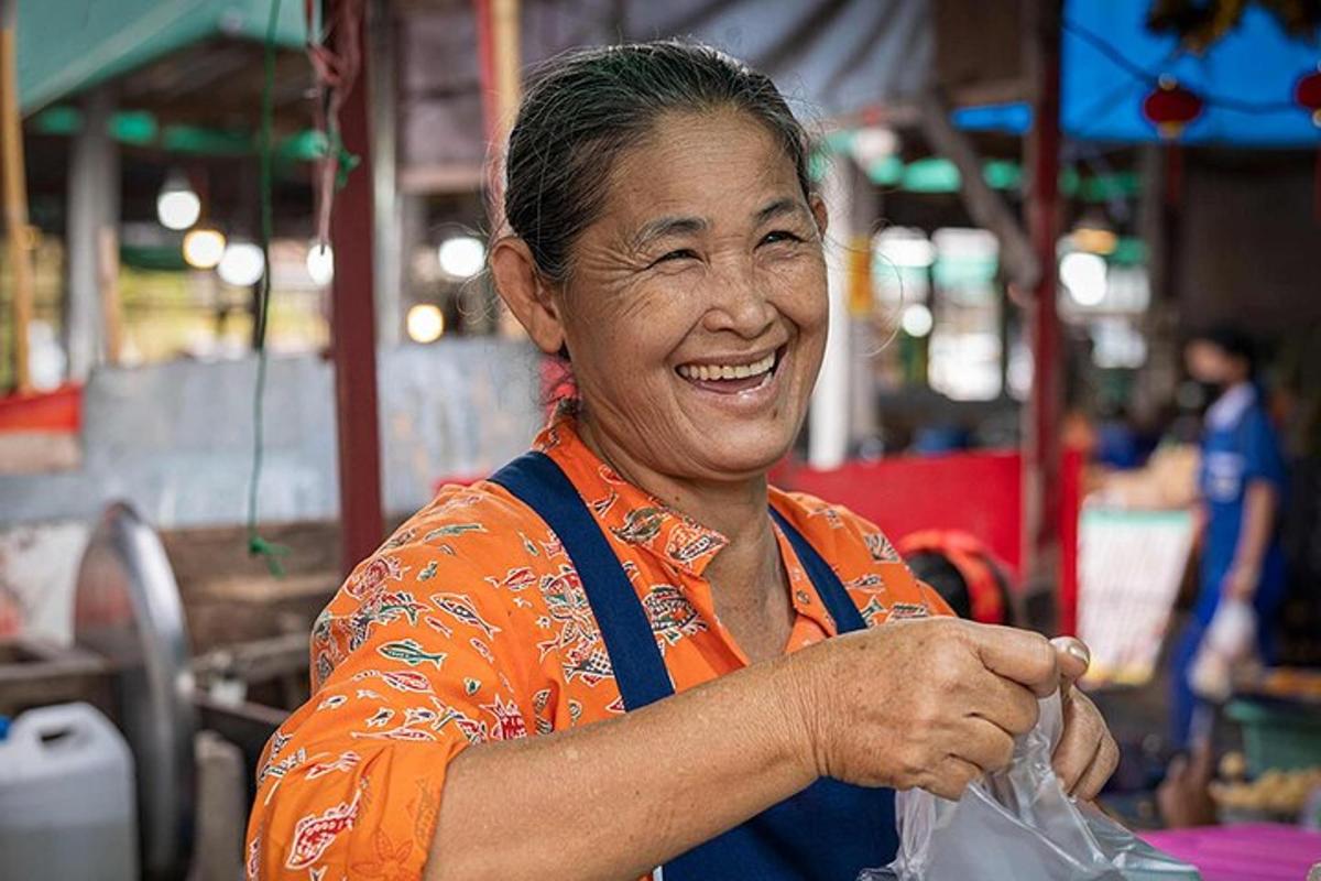 a woman is smiling while holding a plastic bag