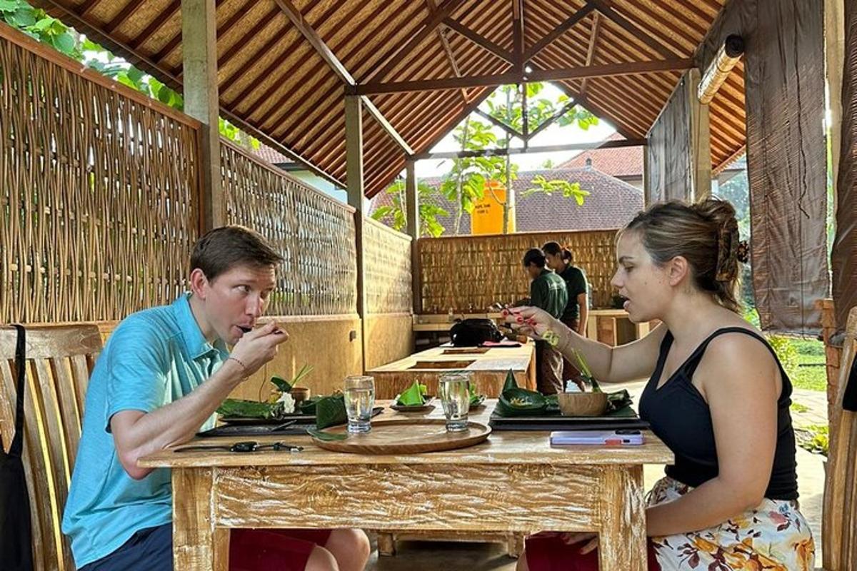 a man and a woman sitting at a table eating food