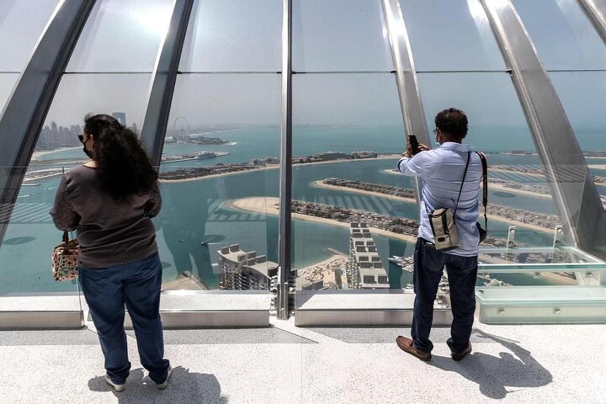 two people looking at the view from the top of a building