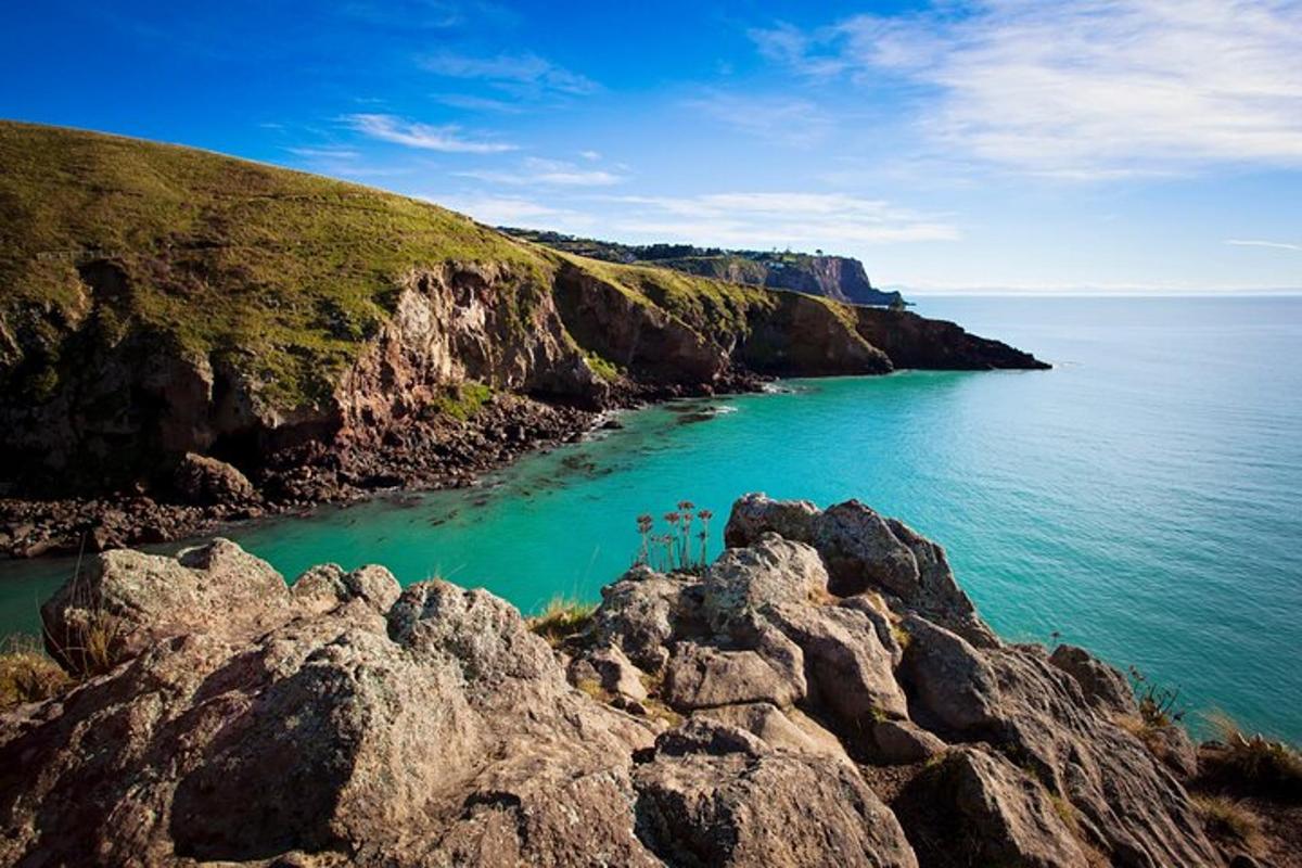 a large body of water with rocks and the ocean