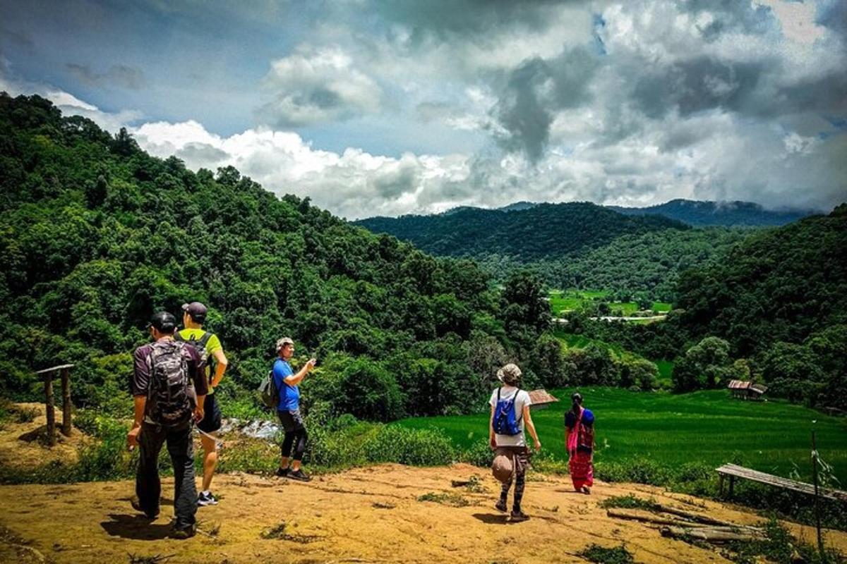 un grupo de personas de pie en la cima de una colina