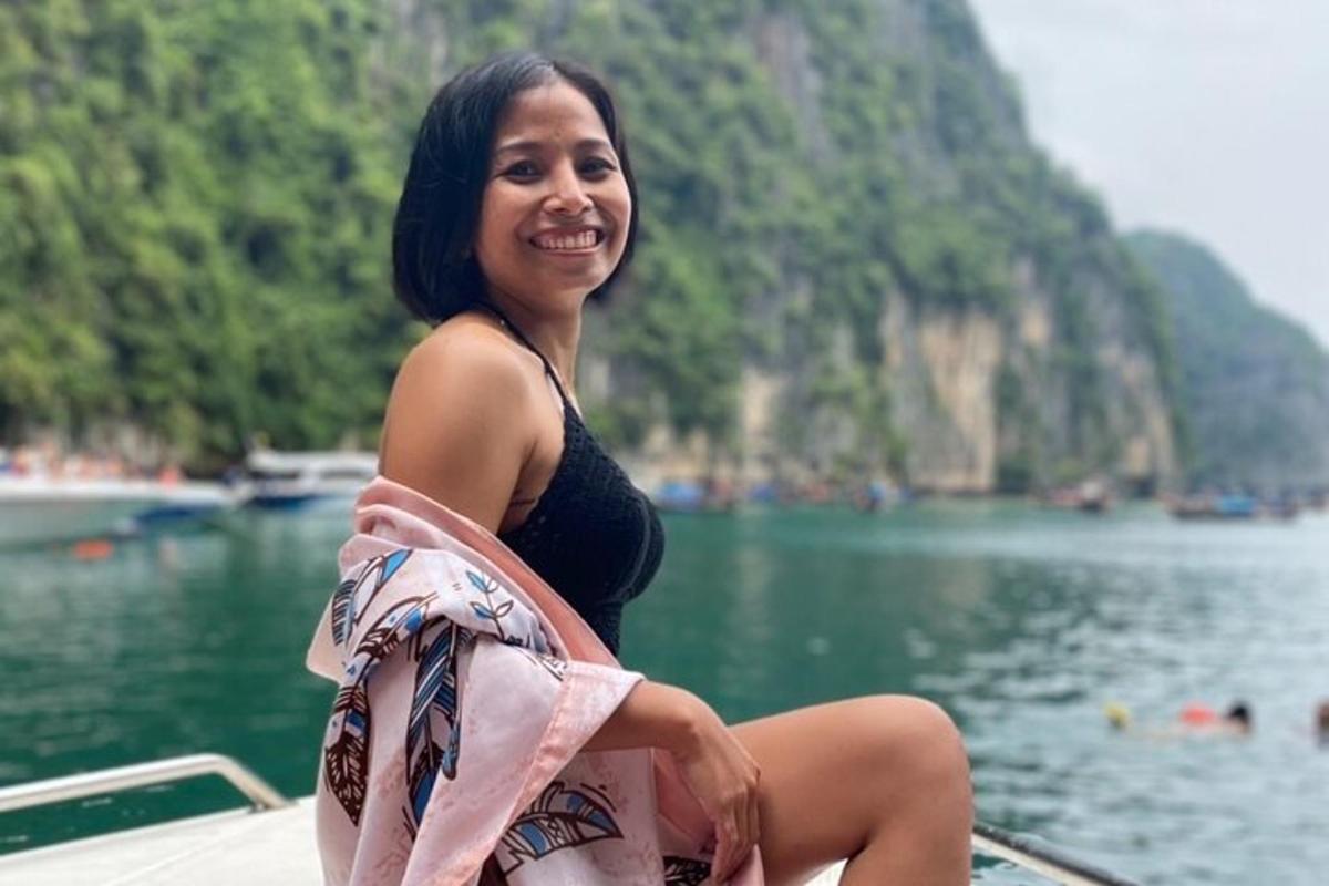 a woman sitting on a boat in the water
