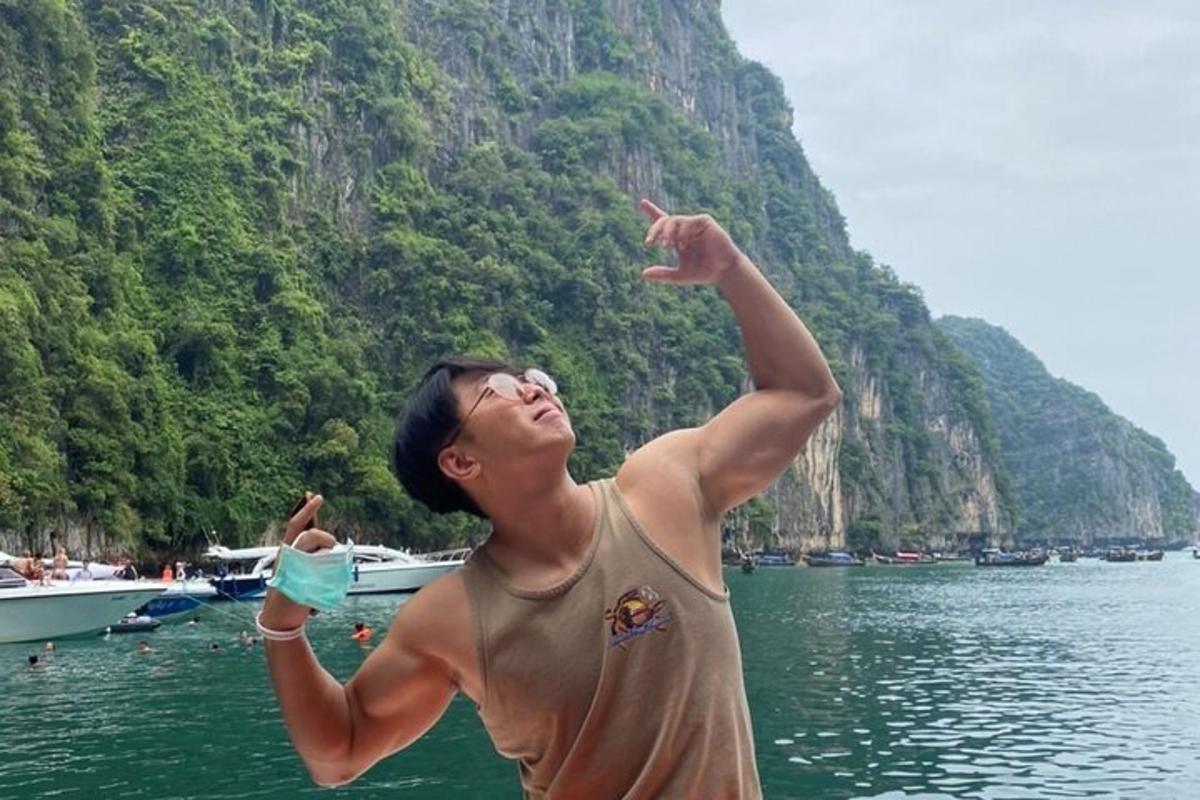 a man is jumping in the water at a beach