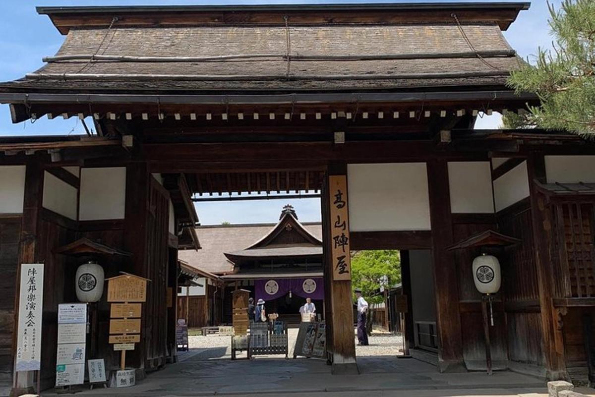 an entrance to a temple with a building in the background