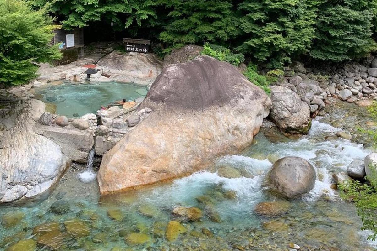 a river with a large rock in the middle