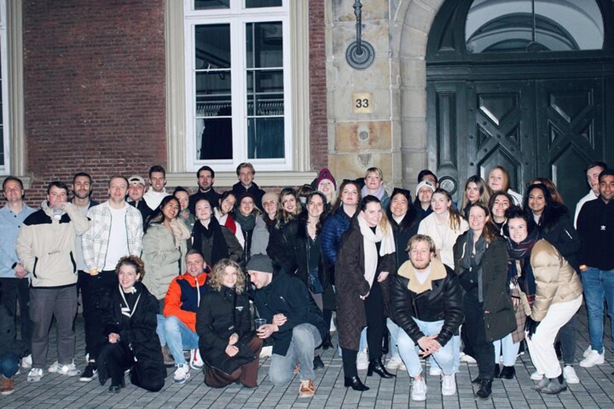 a group of people posing for a picture in front of a building