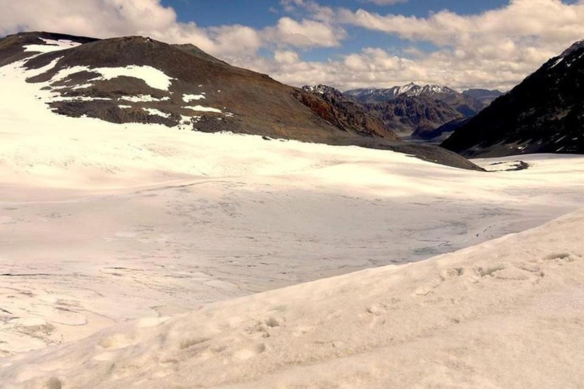 a snow covered mountain with footprints in the snow