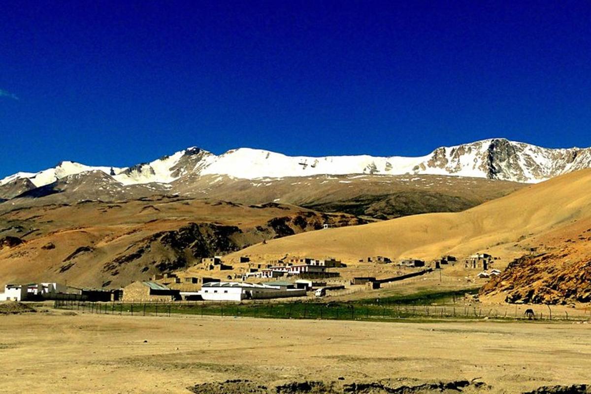 a village in the middle of a snow covered mountain