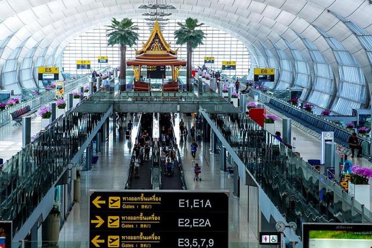 an airport hallway with a sign and palm trees