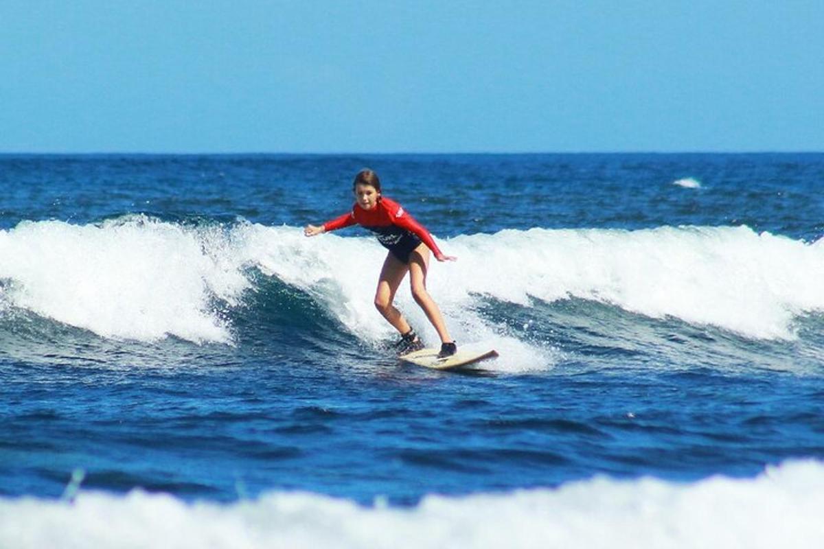 a woman riding a wave on a surfboard in the ocean