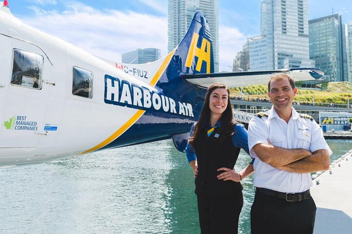 a man and a woman standing in front of an airplane