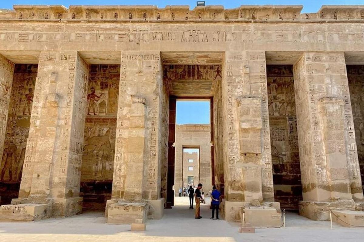 dues persones dempeus davant d'un edifici de pedra