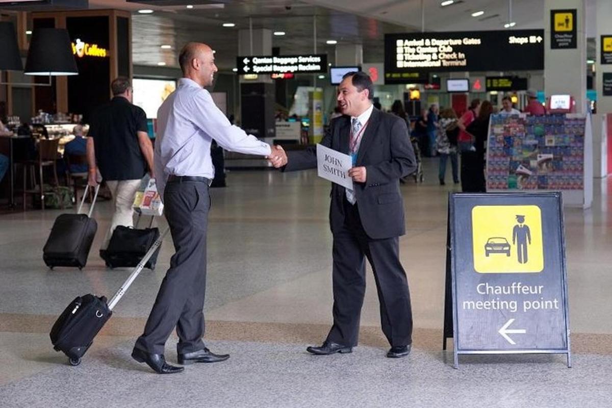 two men shaking hands in an airport terminal