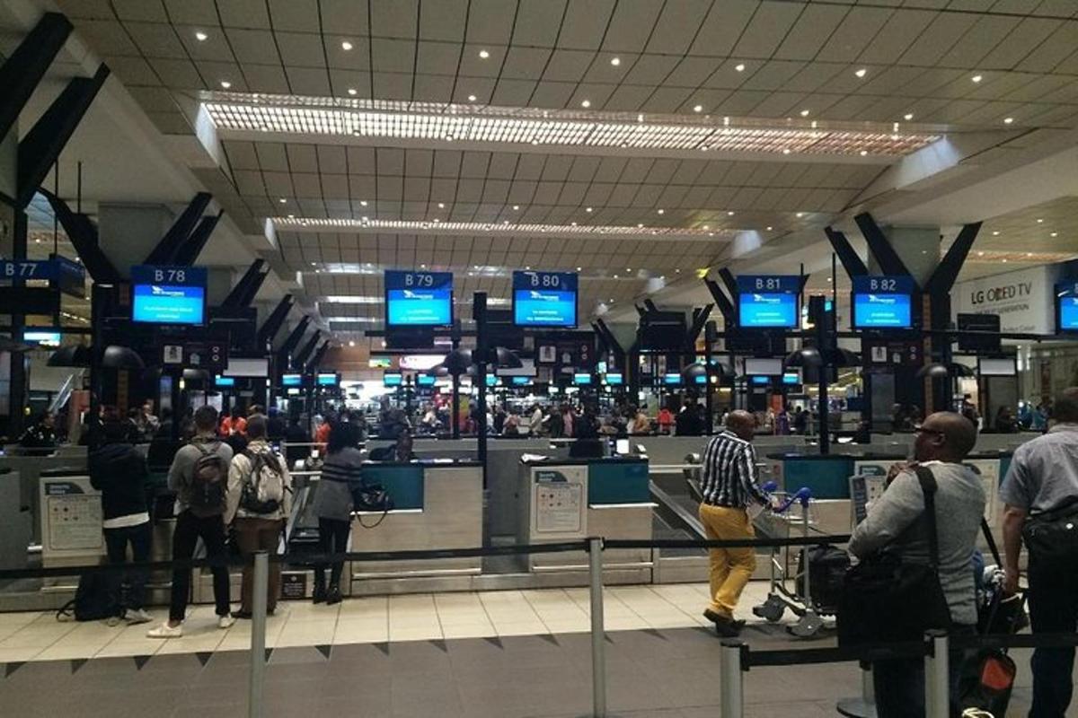 a crowd of people waiting at an airport