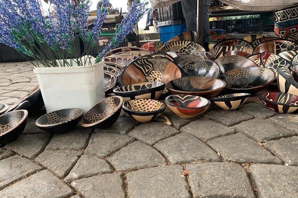 a group of bowls and vases sitting on the ground