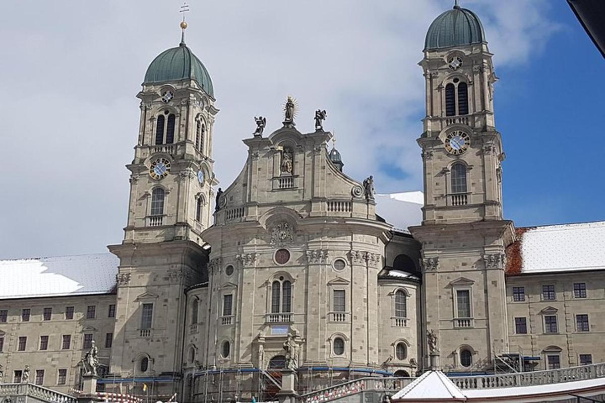 a large building with two towers with clocks on it