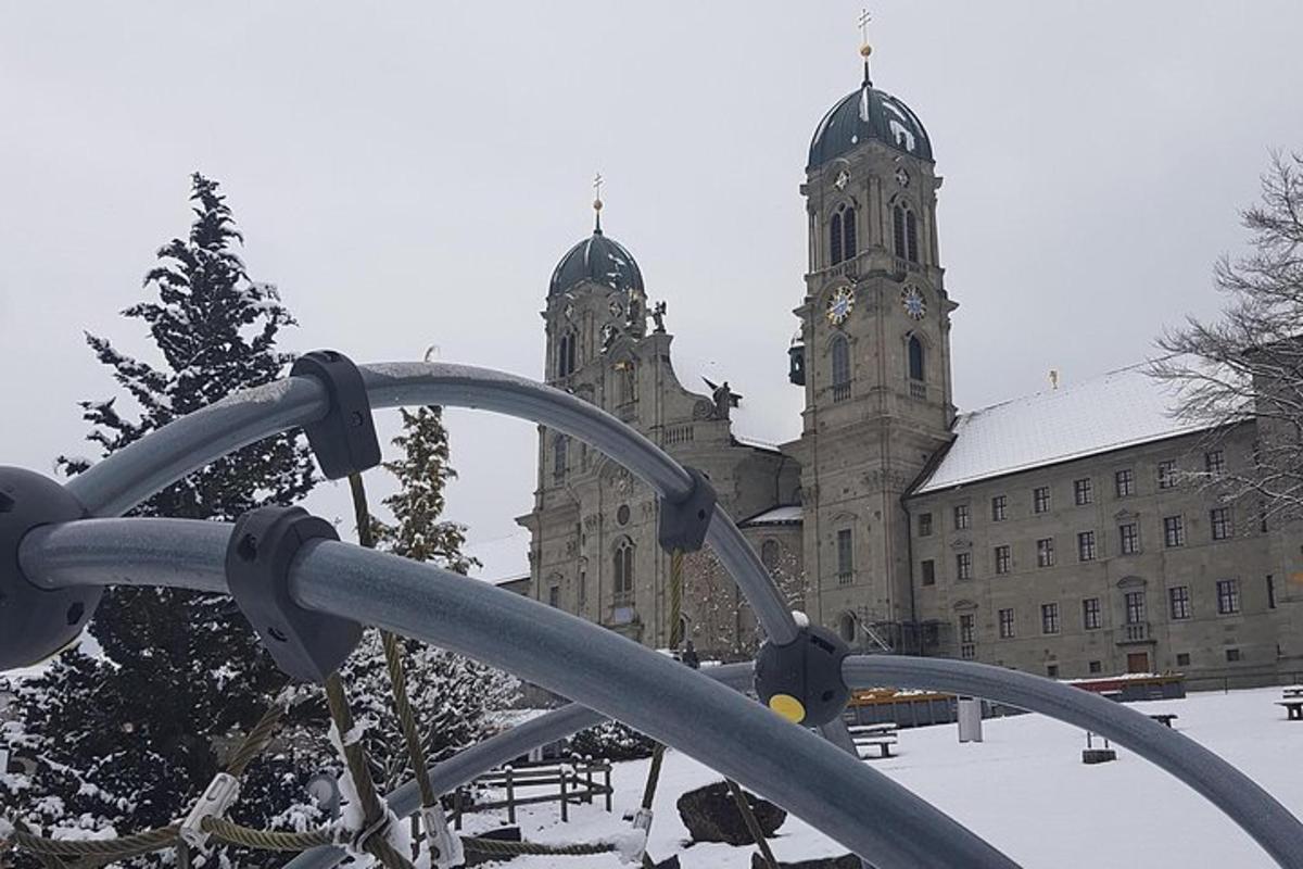 an old building with a clock tower in the snow