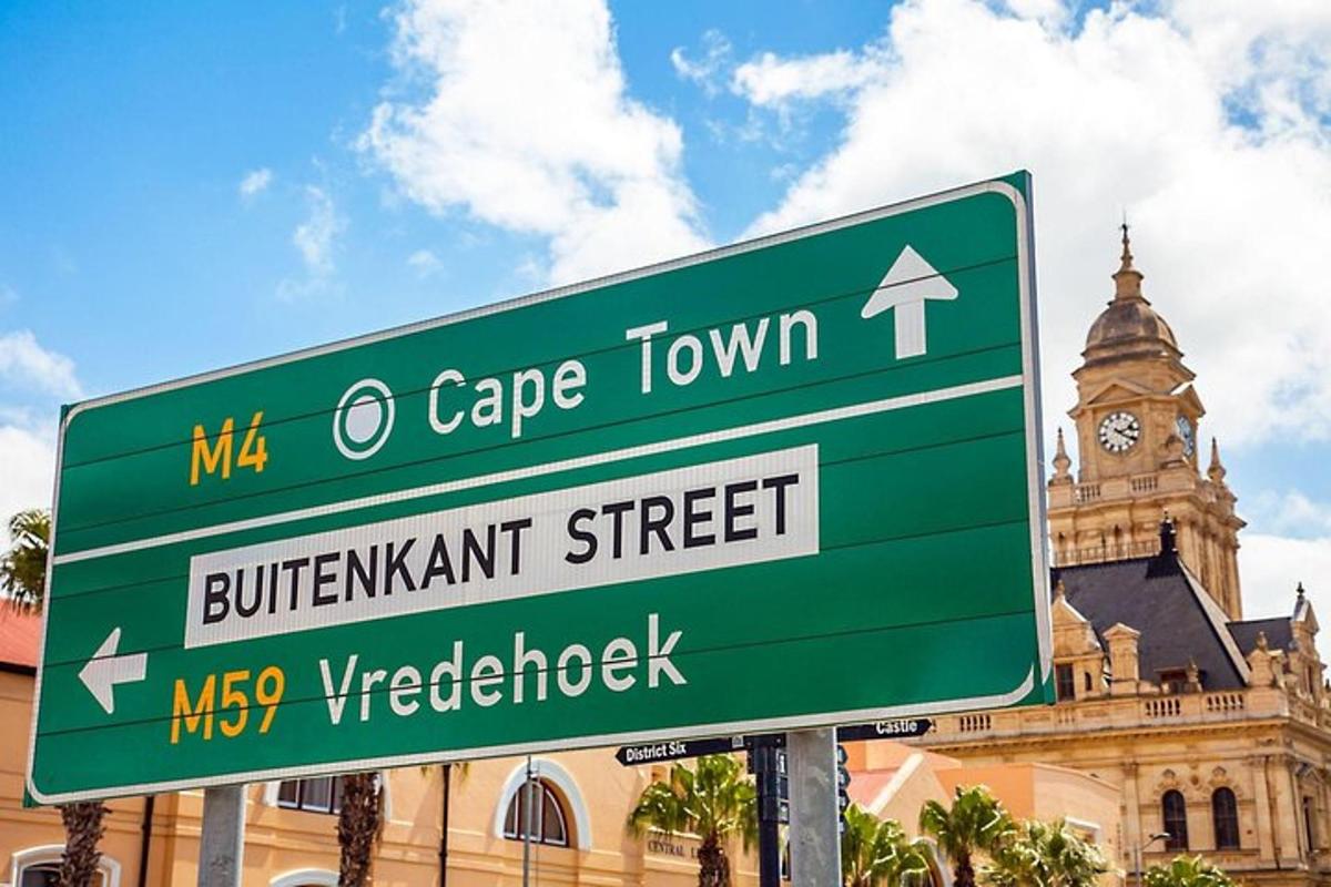a green street sign in front of a building