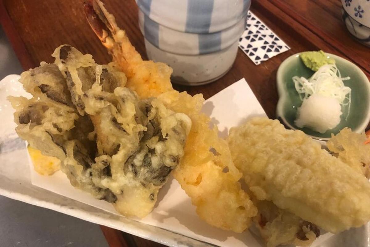 a plate of food with onion rings and a sandwich