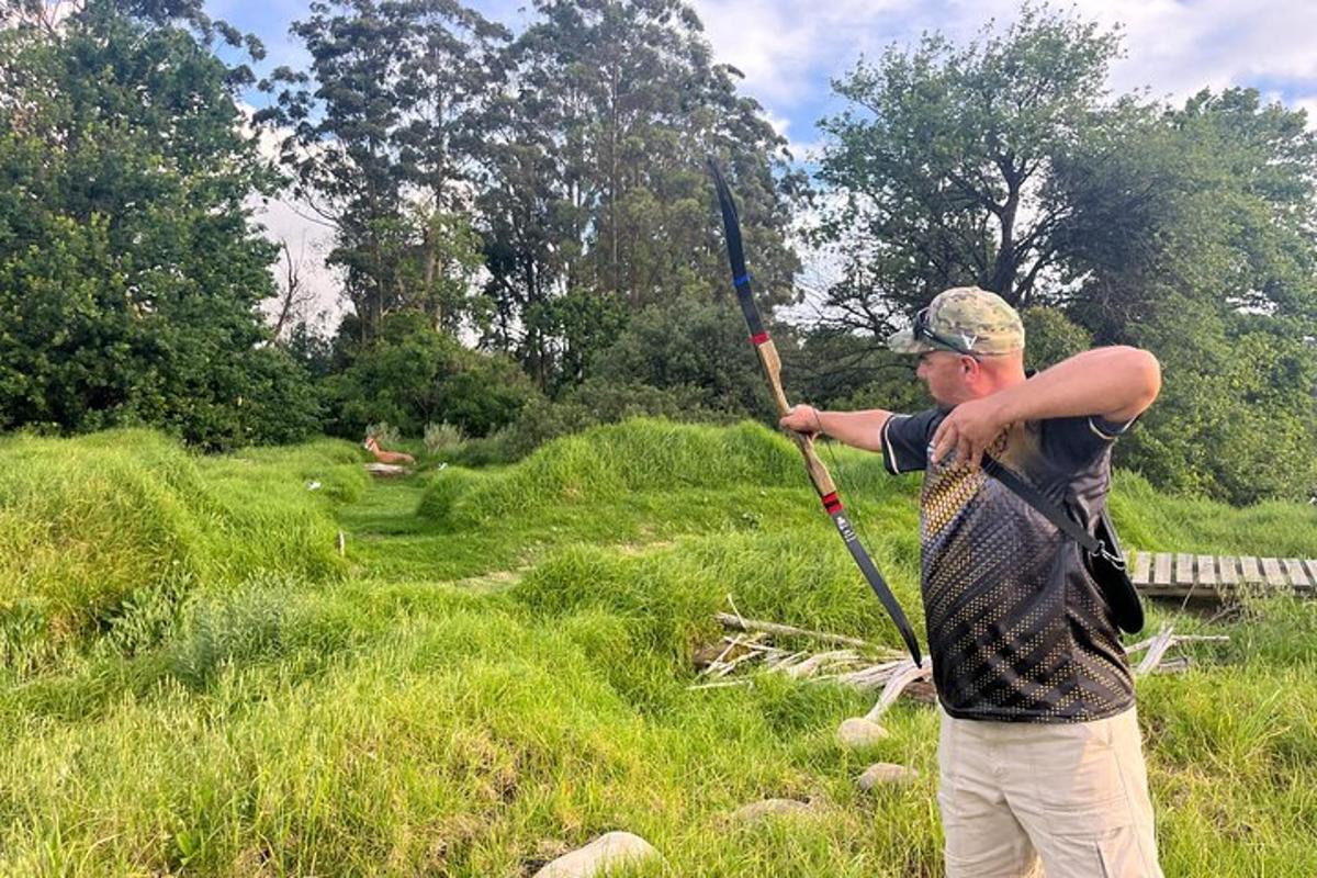 a man holding a stick in a field
