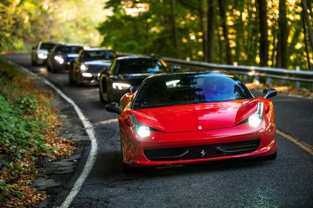 a red car driving down a road with cars