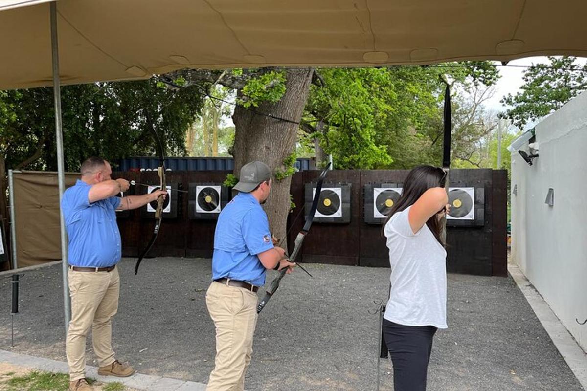 a woman taking a picture of two men with cameras