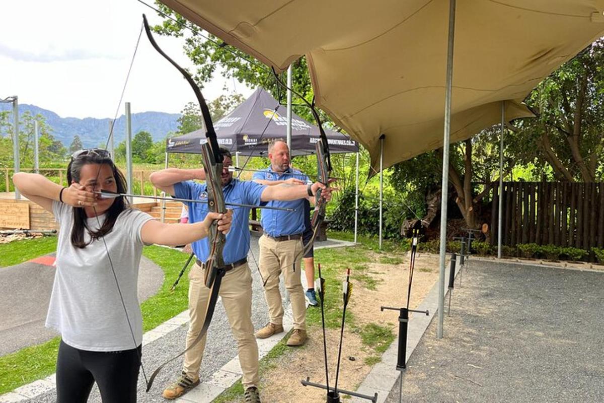 a woman holding up a bow and arrow