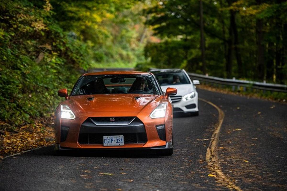 two cars are driving down a road