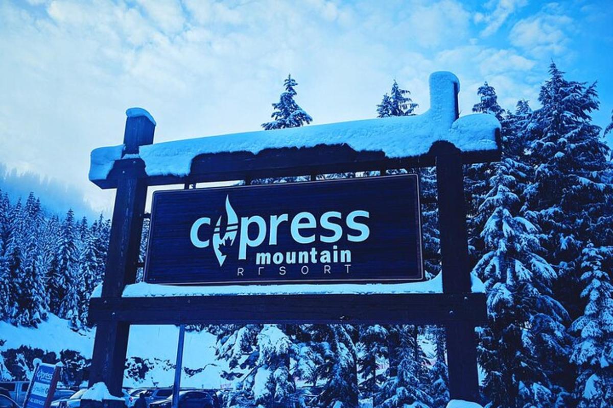 a sign for a mountain resort with snow on it