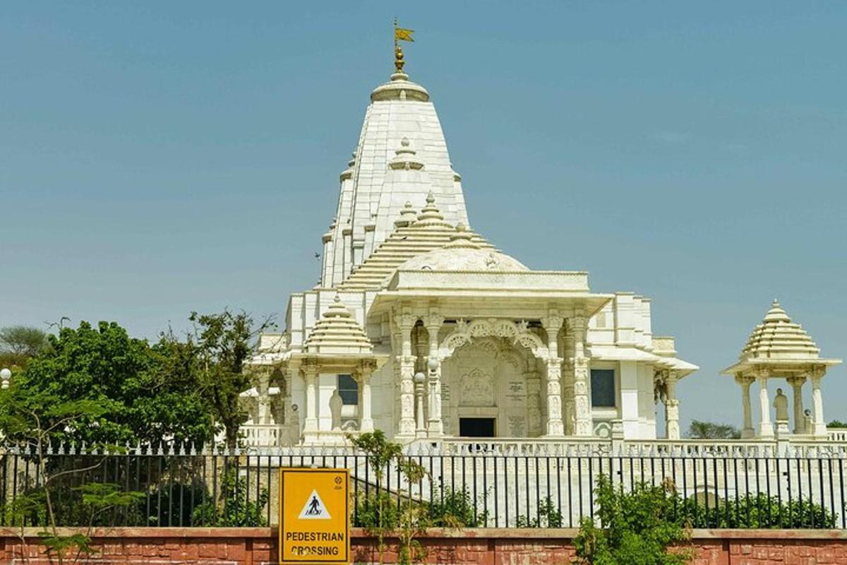 a large white building with a white fence