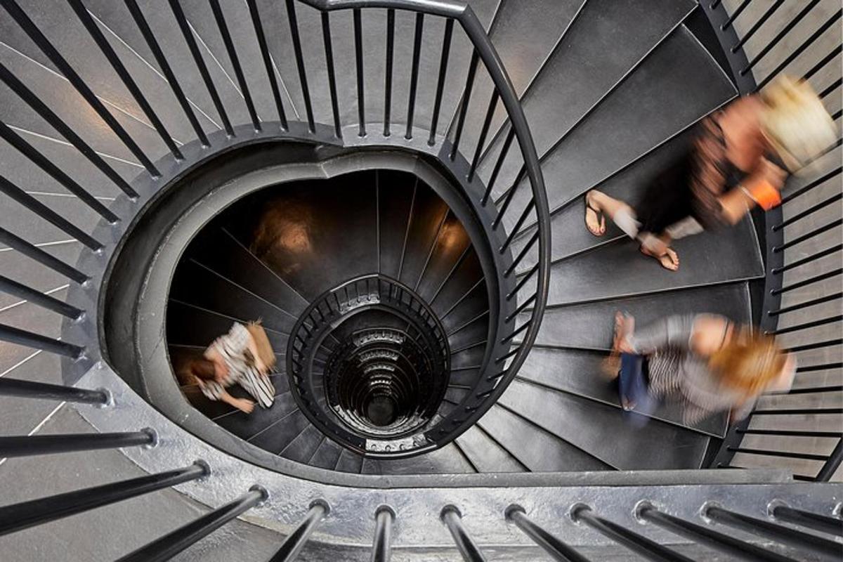a spiral staircase with people walking down it