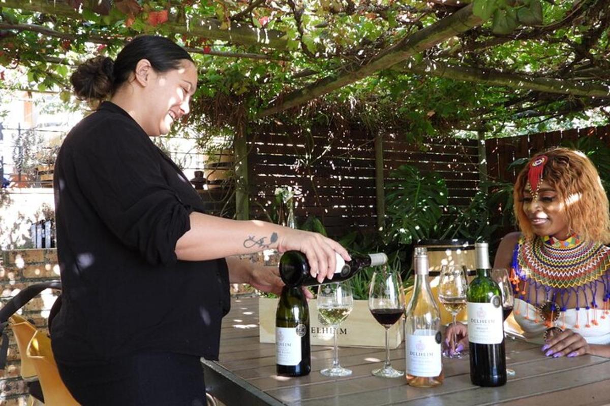 a woman pouring a glass of wine at a table
