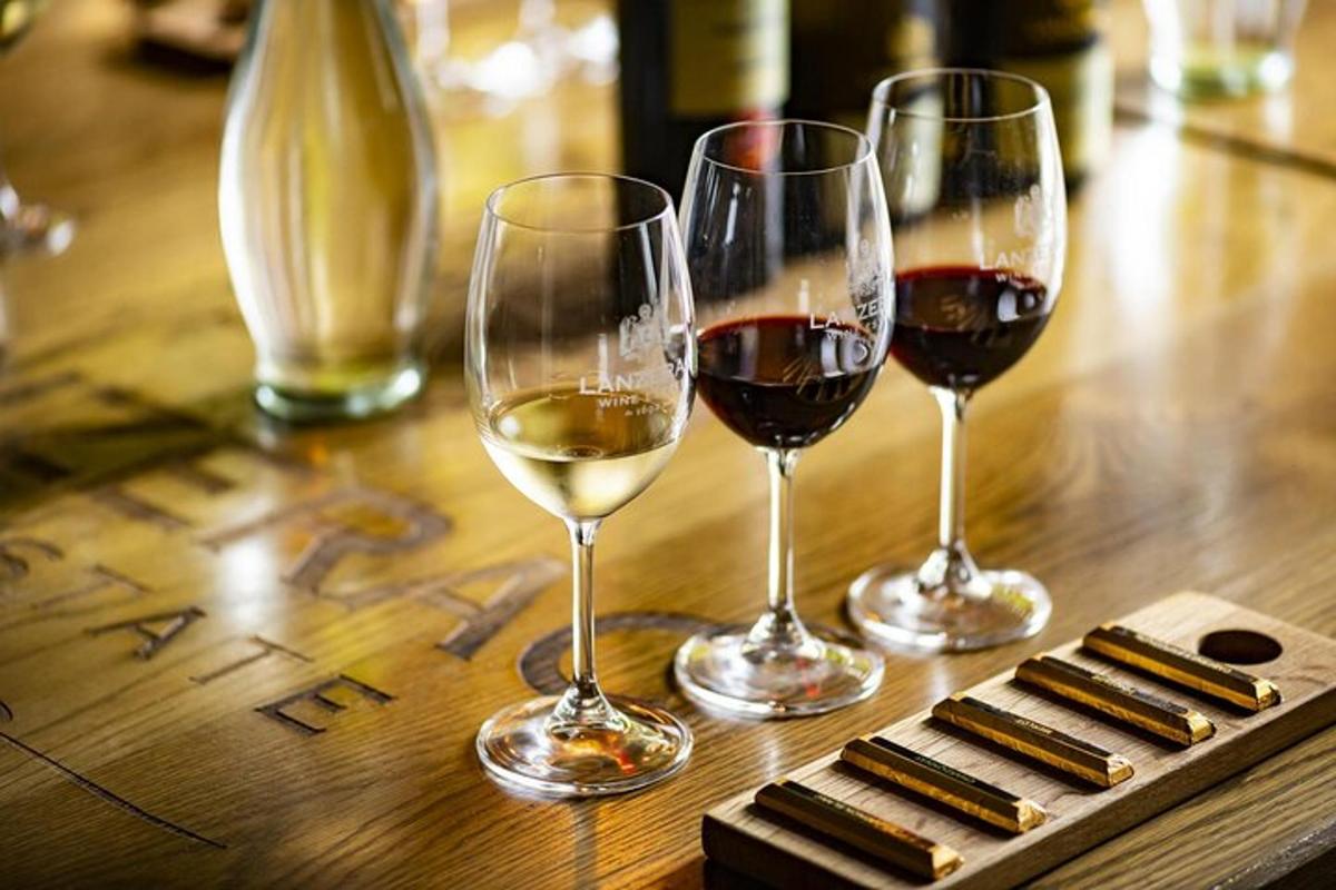 three glasses of wine sitting on a wooden table