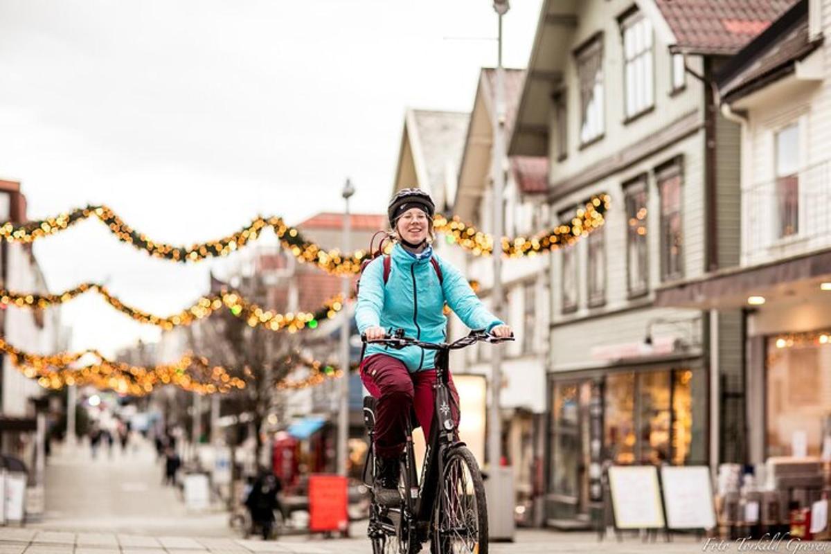 a young girl riding a bike down a street